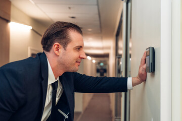 Businessman using face scanner to unlock door in office, Biometric admittance control device for security system.