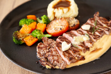Striploin angus steak with mashed potato and grilled vegetable