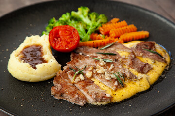 Striploin angus steak with mashed potato and grilled vegetable
