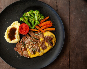 Striploin angus steak with mashed potato and grilled vegetable