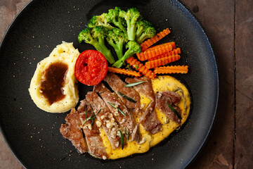Striploin angus steak with mashed potato and grilled vegetable