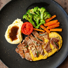 Striploin angus steak with mashed potato and grilled vegetable