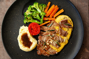 Striploin angus steak with mashed potato and grilled vegetable