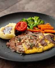Striploin angus steak with mashed potato and grilled vegetable