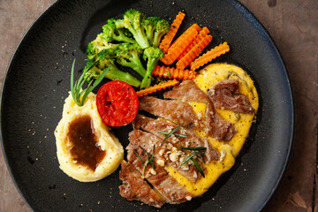 Striploin angus steak with mashed potato and grilled vegetable