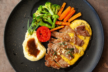 Striploin angus steak with mashed potato and grilled vegetable