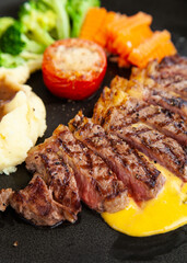 Striploin angus steak with mashed potato and grilled vegetable