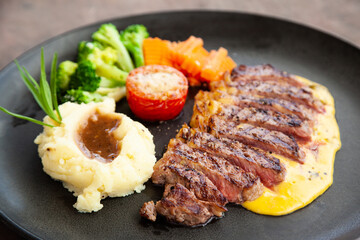 Striploin angus steak with mashed potato and grilled vegetable