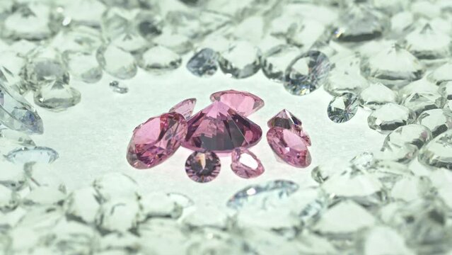 Pink gemstones is displayed on a white background swirling around..Pink diamonds of various sizes and shapes are displayed in the middle of white diamonds..Sweet pink diamonds.white gems background