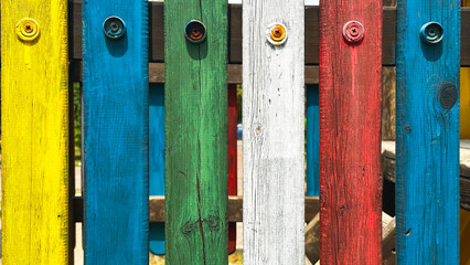 Bright, multi colorful fence on children's playground ,