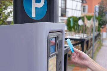 man pays with bank card for time of parking car in street parking meter, rhythm of city life,...