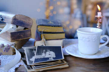 old family photos in vintage interior, stack nostalgic sentimental pictures, photographs 50s,...