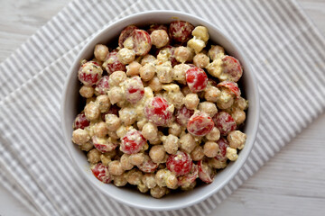 Homemade Pesto Chickpea Snack Salad in a Bowl, top view. Flat lay, overhead, from above.