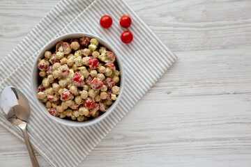 Homemade Pesto Chickpea Snack Salad in a Bowl, top view. Flat lay, overhead, from above. Space for text.