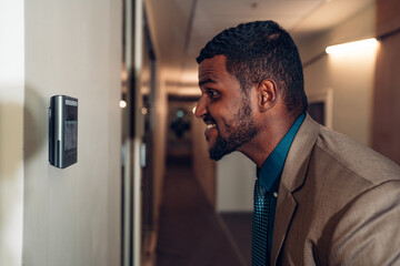 Businessman using face scanner to unlock door in office, Biometric admittance control device for security system.