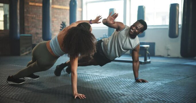 People, high five and push up in gym for fitness, training and exercise teamwork, support and accountability. Young athlete or sports woman and personal trainer hands together and workout on floor