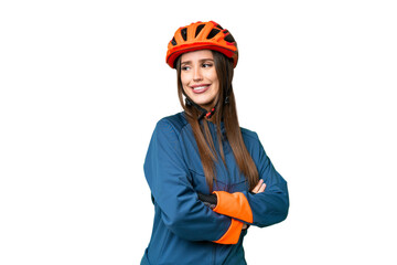 Young cyclist woman over isolated chroma key background with arms crossed and happy - obrazy, fototapety, plakaty