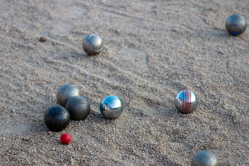 Petanque game. You can see the steel balls of different colors and the magnet they use to collect them.