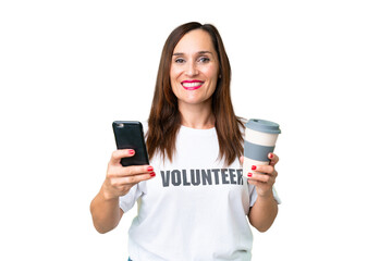 Middle age volunteer woman over isolated chroma key background holding coffee to take away and a mobile