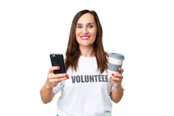 Middle age volunteer woman over isolated chroma key background holding coffee to take away and a mobile