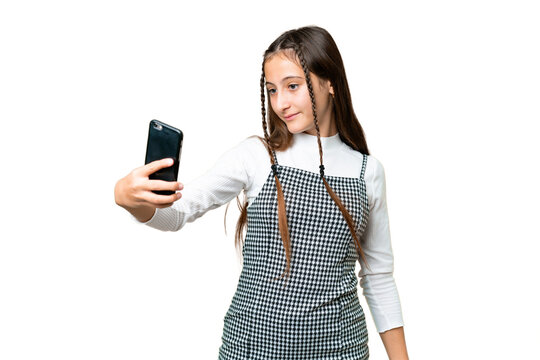 Young girl over isolated chroma key background making a selfie
