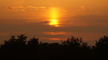Sunset over the field near the house