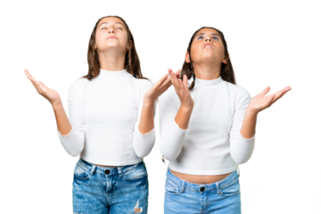 Friends girls holding gift and a birthday cake over isolated chroma key background frustrated by a bad situation