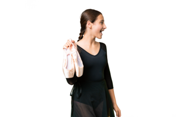 Young woman practicing ballet over isolated chroma key background laughing in lateral position