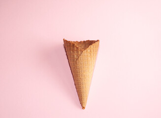 Ice cream cone on pastel pink background. Minimal summer concept, Flat lay. No people. Perfect for background.