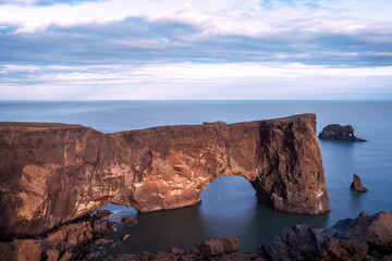 Fototapeta na wymiar Arch rock in Iceland, kirk cliffs of moher at sunset