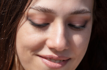 Close-up portrait of a beautiful young woman with eyes closed