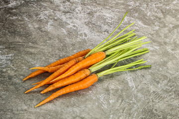 Young raw carrot heap isolated