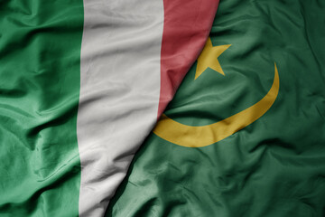 big waving national colorful flag of italy and national flag of mauritania .