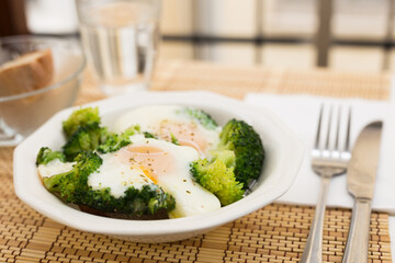 Breakfast of crumpled eggs with broccoli