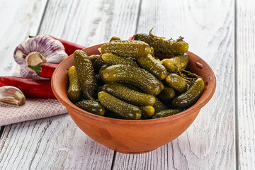 Marinated small cucumbers in the bowl