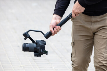 The operator shoots a video holding a professional video camera in his hands