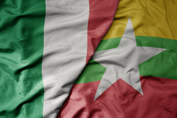 big waving national colorful flag of italy and national flag of myanmar .