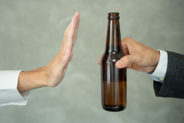 man refuses say no and avoid to drink an alcohol whiskey , stopping hand sign male, alcoholism treatment, alcohol addiction, quit booze, Stop Drinking Alcohol. Refuse Glass liquor, unhealthy, reject