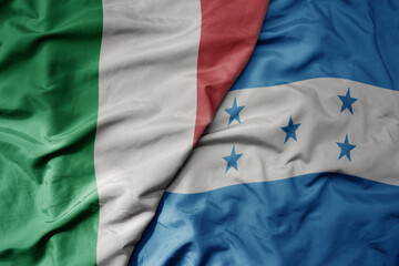 big waving national colorful flag of italy and national flag of honduras .