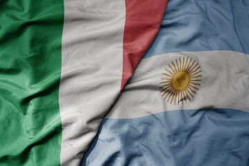 big waving national colorful flag of italy and national flag of argentina .