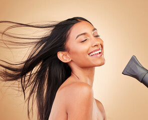 Woman, hair with dryer and wind, beauty and cosmetics tools with shine isolated on studio background. Heat treatment, keratin and wellness with straight hairstyle, electric appliance and growth