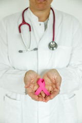Doctor woman with pink ribbon in hand and stethoscope, Breast cancer awareness day 