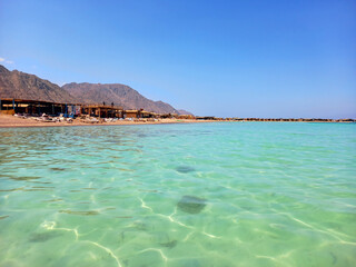 Panoramic view of turquoise waters of the Red Sea with Desert mountains. Extreme landscapes and vacation spots.