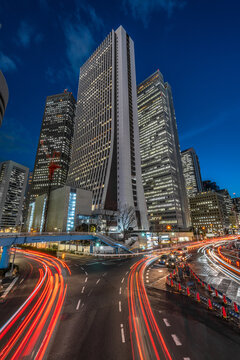 Shinjuku, Tokyo - March 14, 2019 : Cityscape at night. Vehicles red light trails and skyscrapers at business district in Tokyo