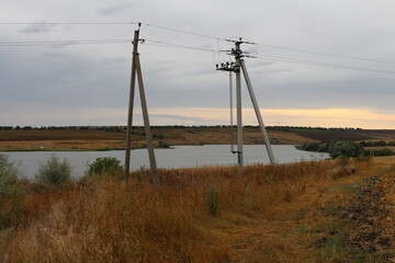 Power lines on a river bank