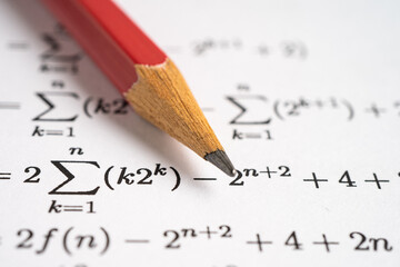 Pencil on mathematic formula exercise test paper in education school.