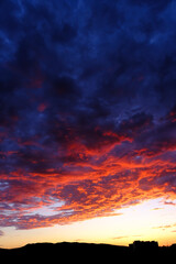 Sunset or Sunrise in Sky Dramatic Clouds with Mountains and a Building
