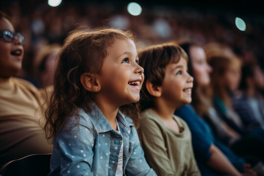 Side view of a children audience enjoying a kids concert or movie with happy smiling faces