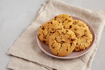 Homemade Cookies with Milk Chocolate Chunks on a Plate, side view. Copy space.