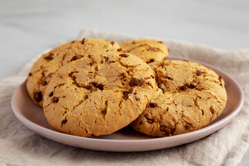 Homemade Cookies with Milk Chocolate Chunks on a Plate, side view. Close-up.